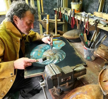 Handcrafted copper sculpture with aging patina displayed in a high-end interior, by Irish artist Richard Andreucetti